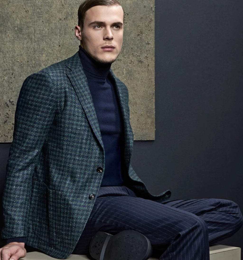 The lux color combination of emerald and navy compliment each other beautifully. We offer this jacket of wool & silk blend.