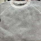 A product of Australia, this soft to the touch an ultra comfortable crewneck sweater features a contrast on the collar, sleeve and bottom along with stitching.