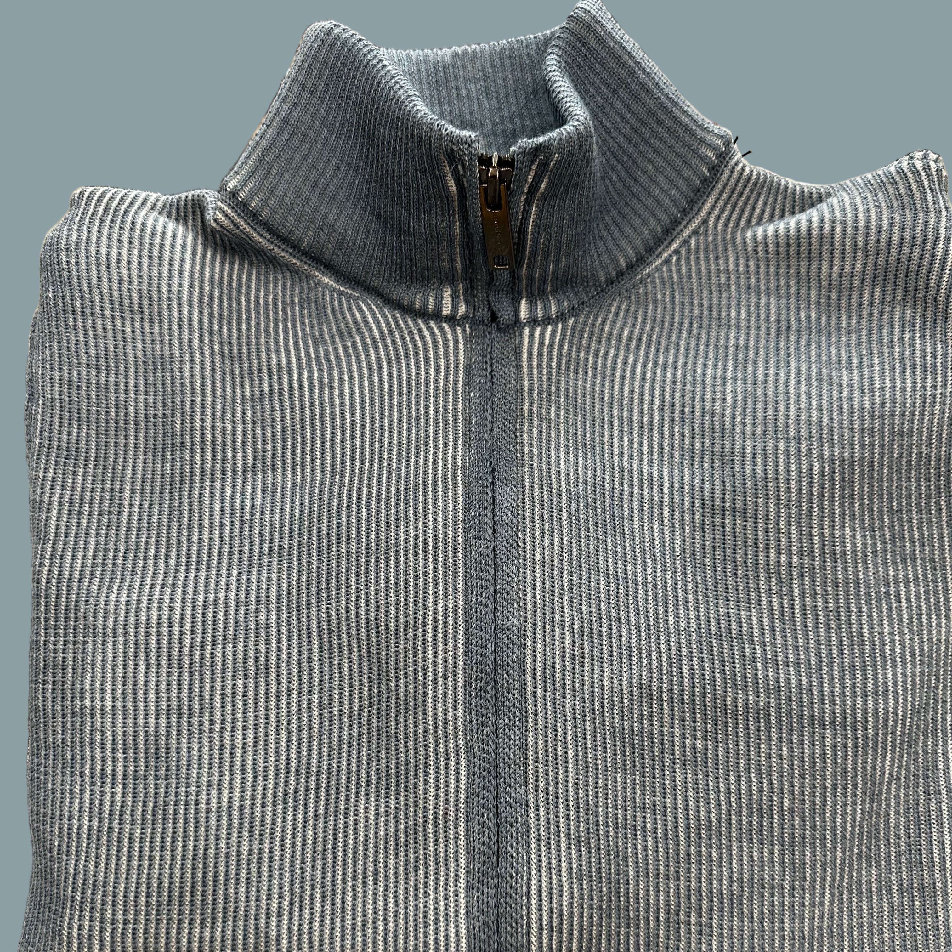A product of Austria, this full zip cardigan sweater, is made from a fine merino wool blend.