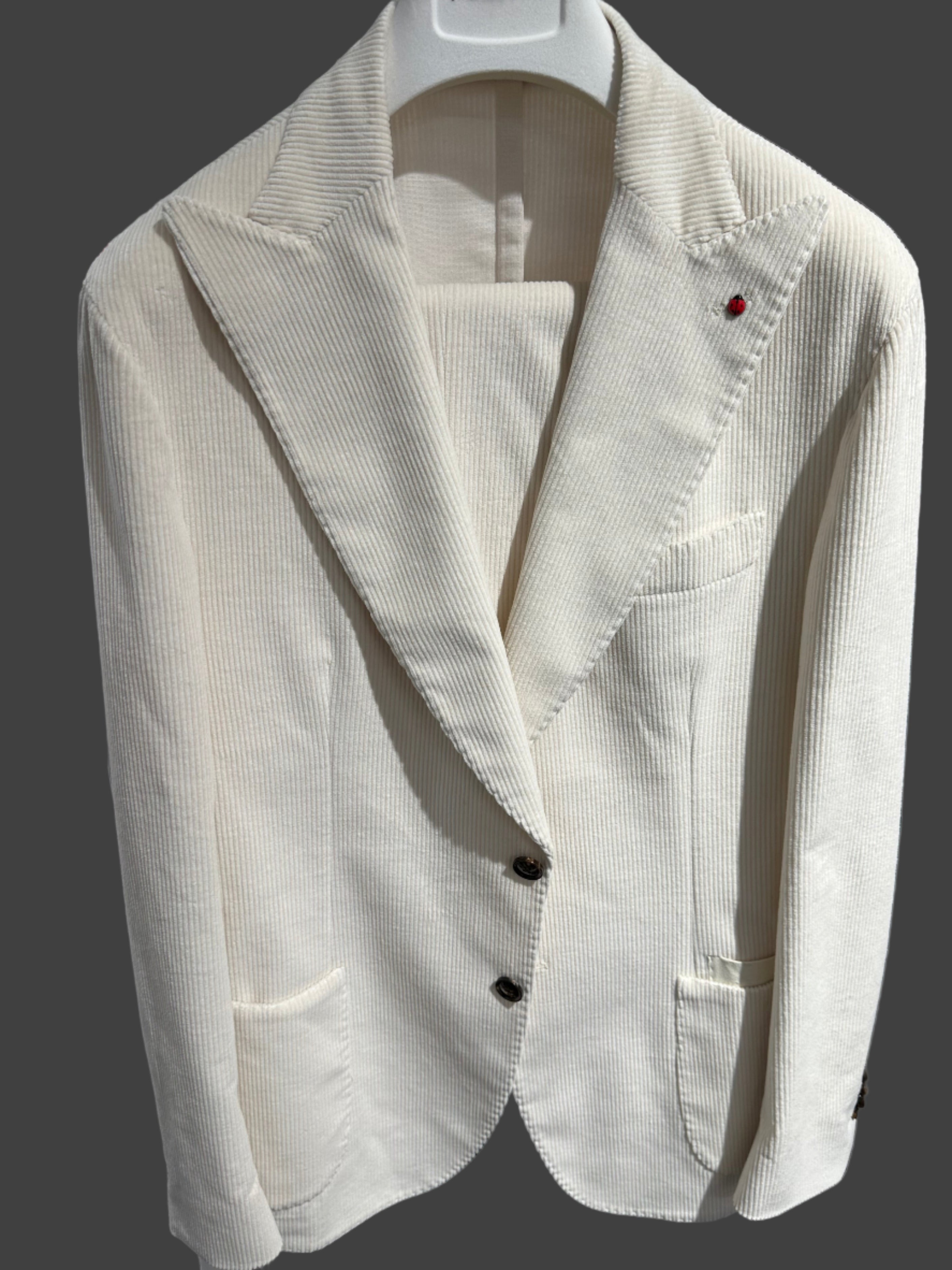 Our made in Puglia, IT suit made by Fugato. It is offered in a cotton cord blend fabric. Styled with a Peak Lapel and a draw string waist band trouser.