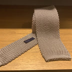A knit tie with a textured pattern.
